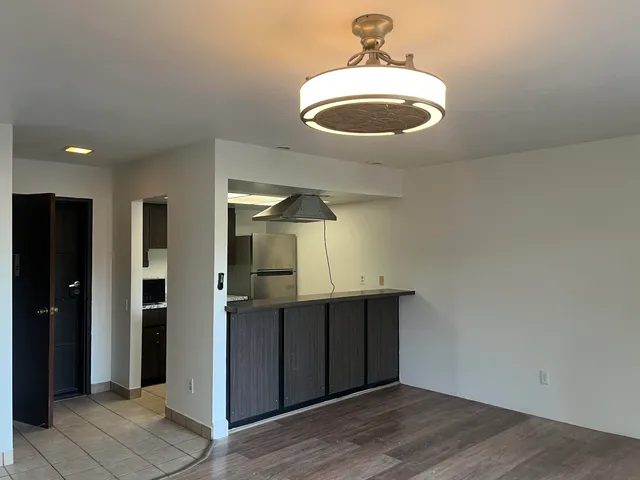 a view of a livingroom with wooden floor and window