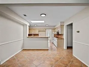 a view of kitchen with refrigerator and window