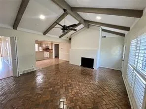 a view of a hallway with wooden floor and a fireplace