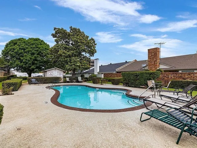 a swimming pool with outdoor seating and yard