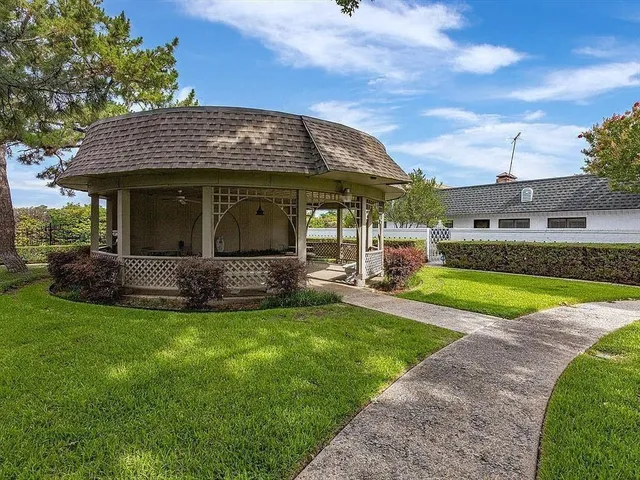 a view of a house with swimming pool and a yard