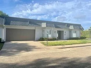 a view of yellow house with a street