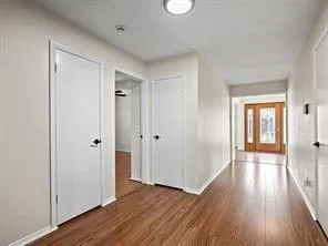 a view of a hallway with wooden floor