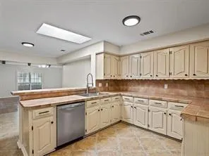 a kitchen with a sink and cabinets