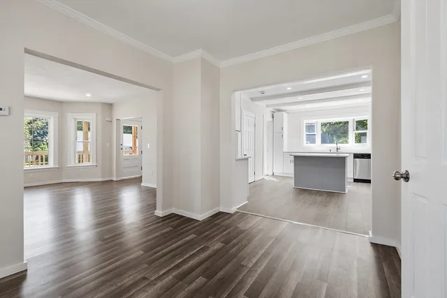 a view of a big room with wooden floor and windows