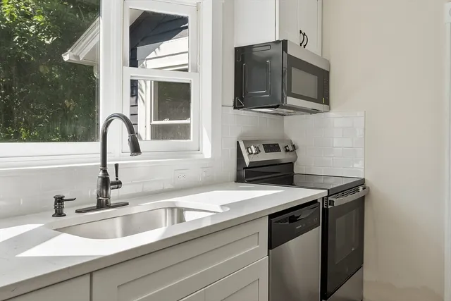 a kitchen with a sink and a microwave