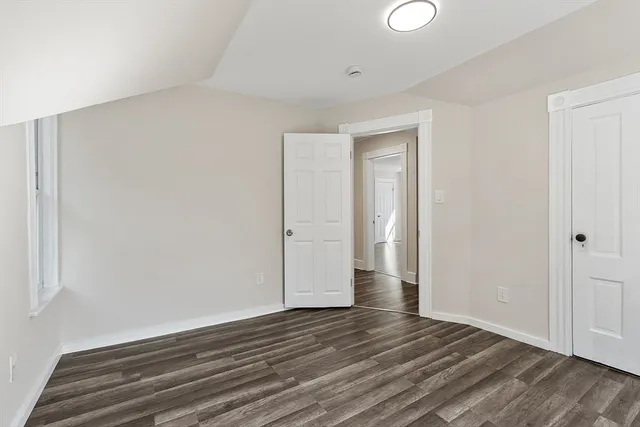 a view of wooden floor and windows in a room