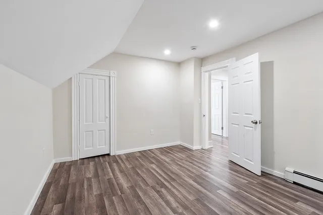 a view of hallway with wooden floor