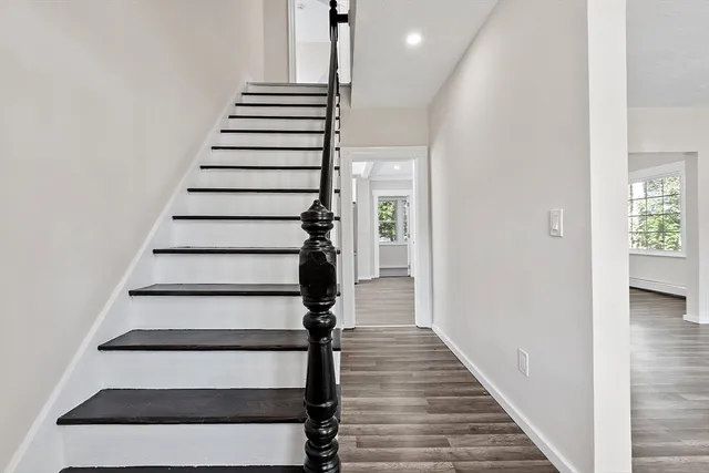 a view of entryway and hall with wooden floor