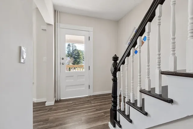 a view of entryway with wooden floor and stairs