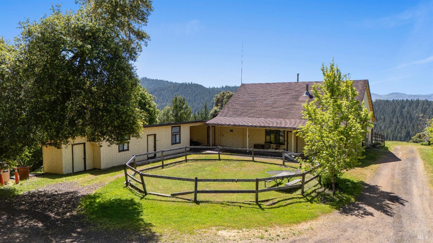9655 Peachland Road Boonville, CA 95415 - Photo 29 of 40 a view of a white house with a swimming pool and a yard