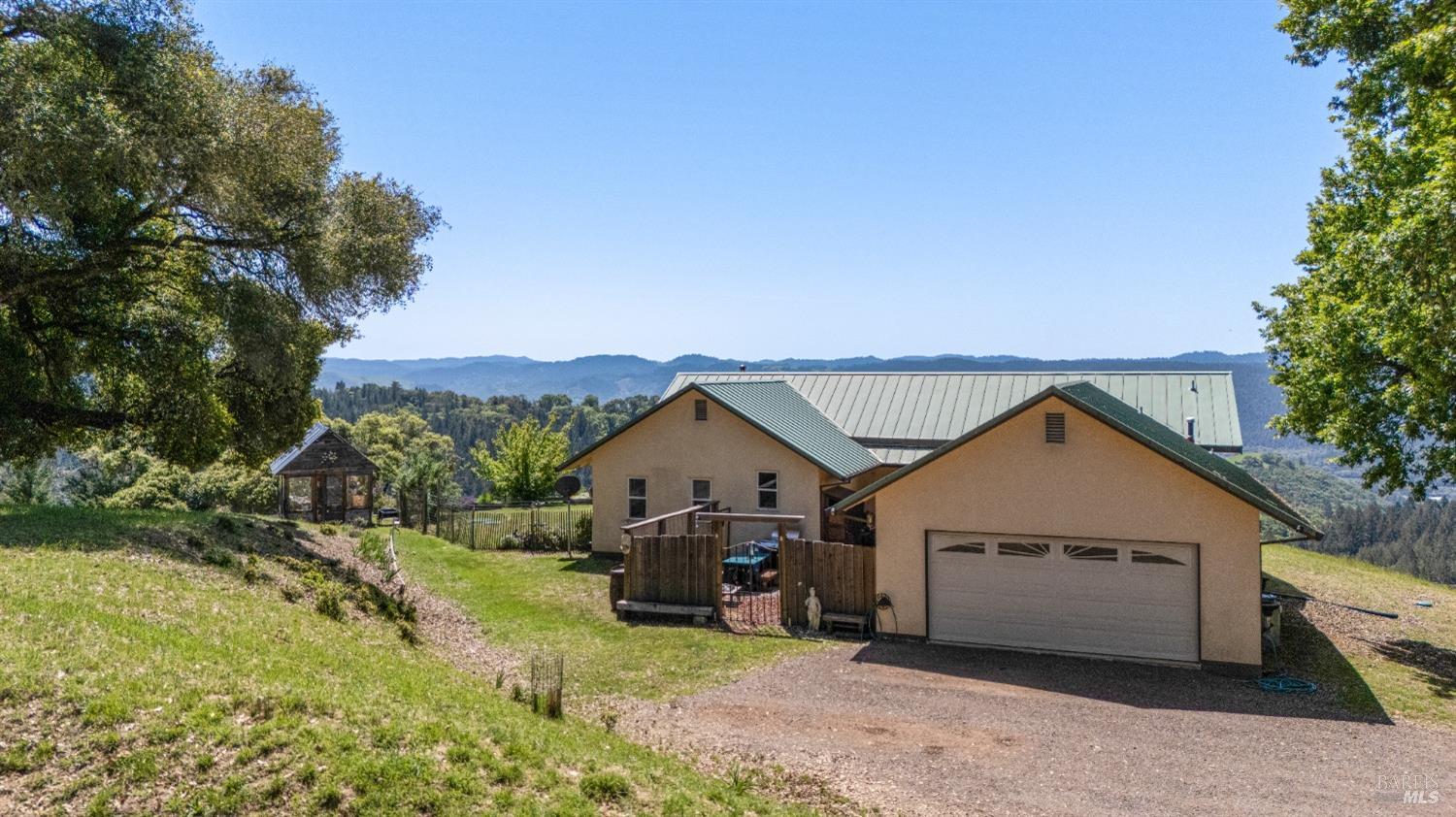 9655 Peachland Road Boonville, CA 95415 - Photo 7 of 40 a view of a house with a yard and garage