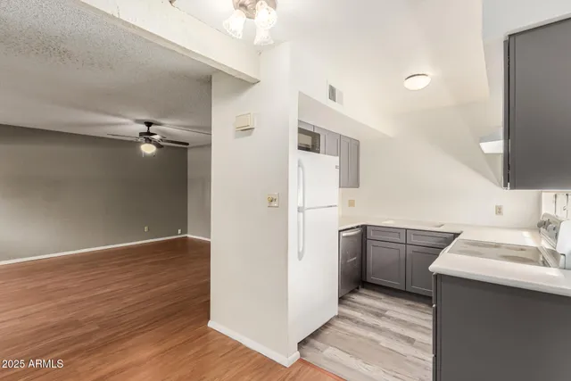 a kitchen with a sink a refrigerator and a stove top oven