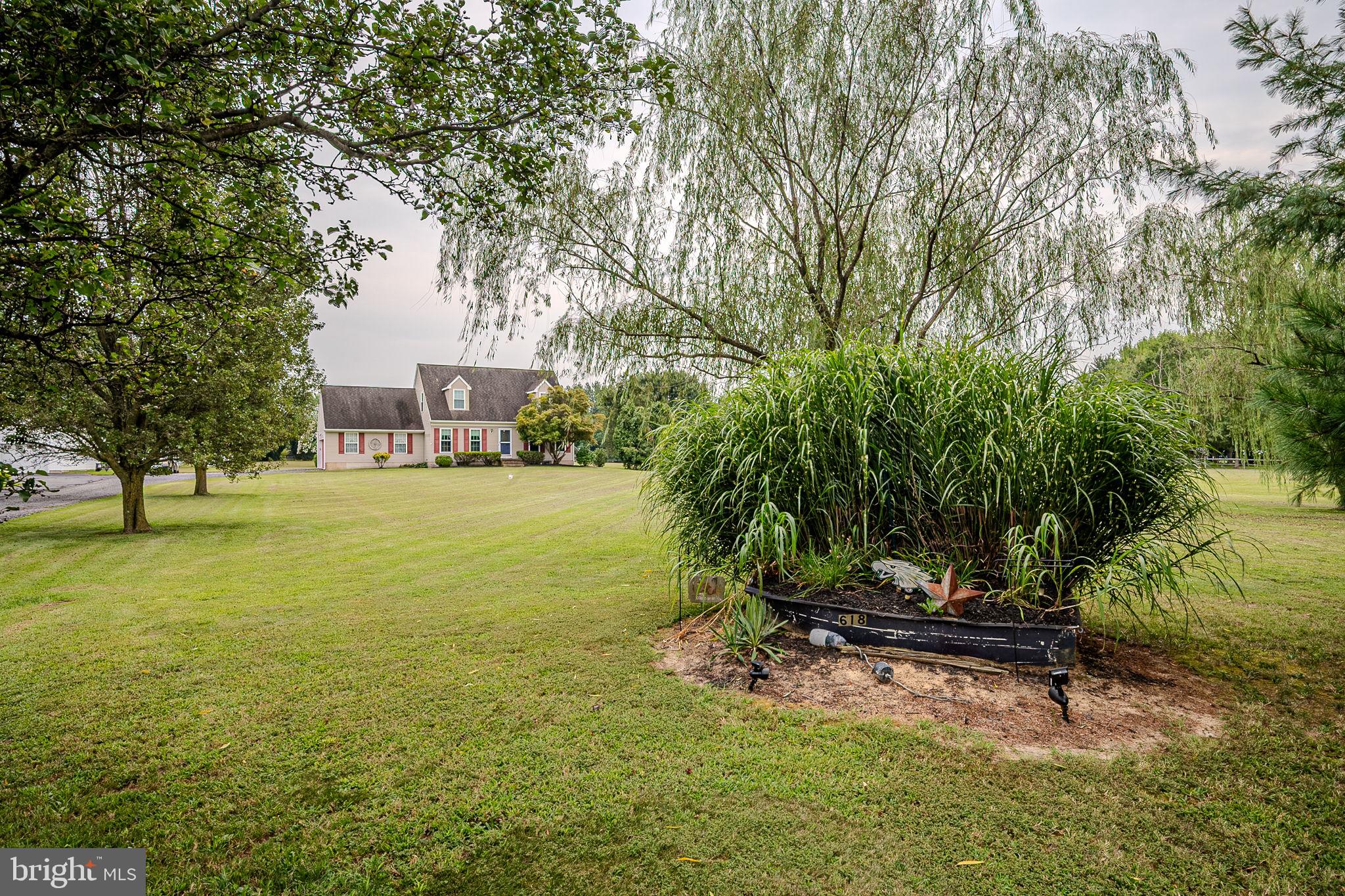 a view of a lake with a bench and trees around