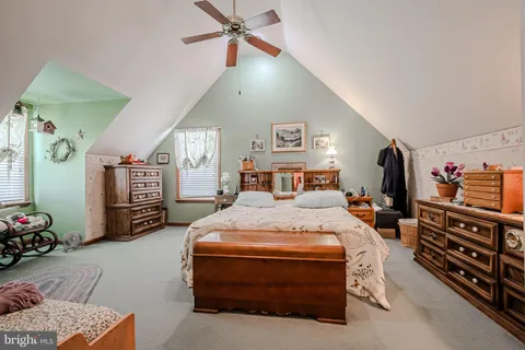 a bedroom with a bed a dresser and book self