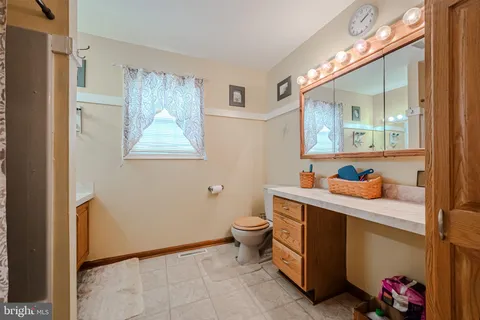 a bathroom with a toilet sink and mirror