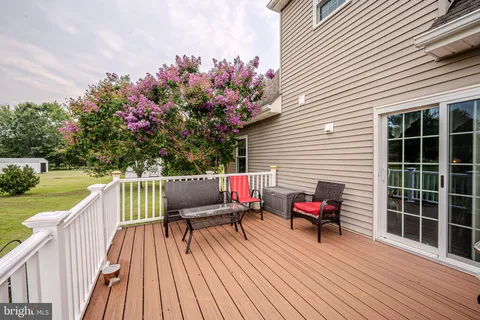 a balcony with wooden floor and furniture