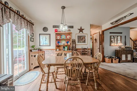 a view of a dining room with furniture and a chandelier