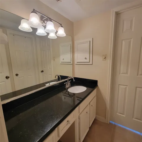 a spacious bathroom with a double sink and a mirror