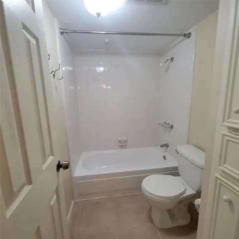 a bathroom with a toilet and a bath tub