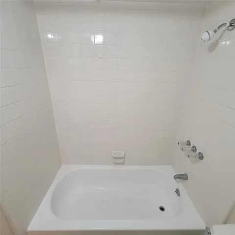 a white bath tub sitting in a bathroom