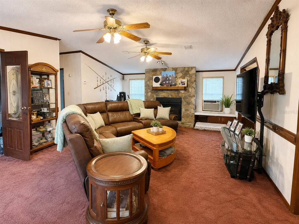 2665 Absher Road St. Cloud, FL 34771 - Photo 18 of 27 a living room with furniture a window and a fireplace