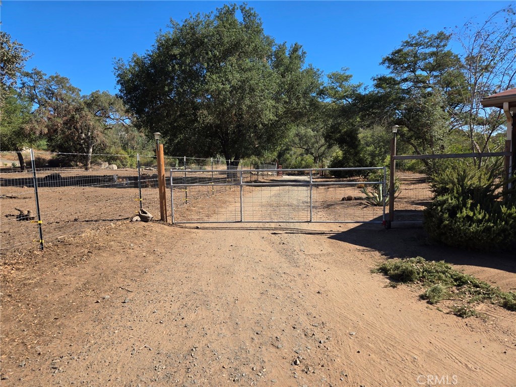 a view of a yard with wooden fence