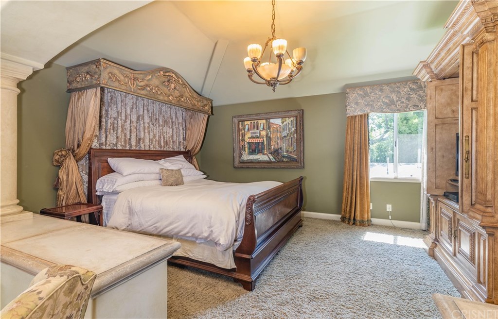 15237 Sutton Street Sherman Oaks, CA 91403 - Photo 15 of 31 a spacious bedroom with two beds and a chandelier