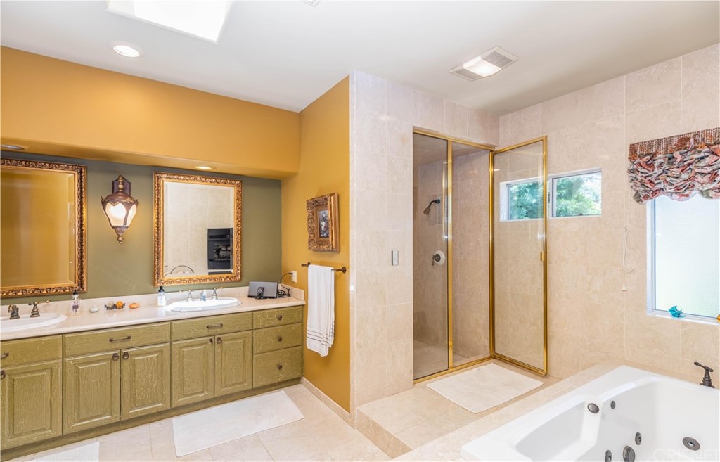 15237 Sutton Street Sherman Oaks, CA 91403 - Photo 17 of 31 a spacious bathroom with a double vanity sink a mirror and a shower