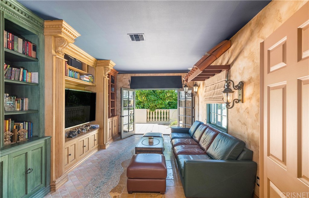 15237 Sutton Street Sherman Oaks, CA 91403 - Photo 20 of 31 a living room with furniture a flat screen tv and a floor to ceiling window