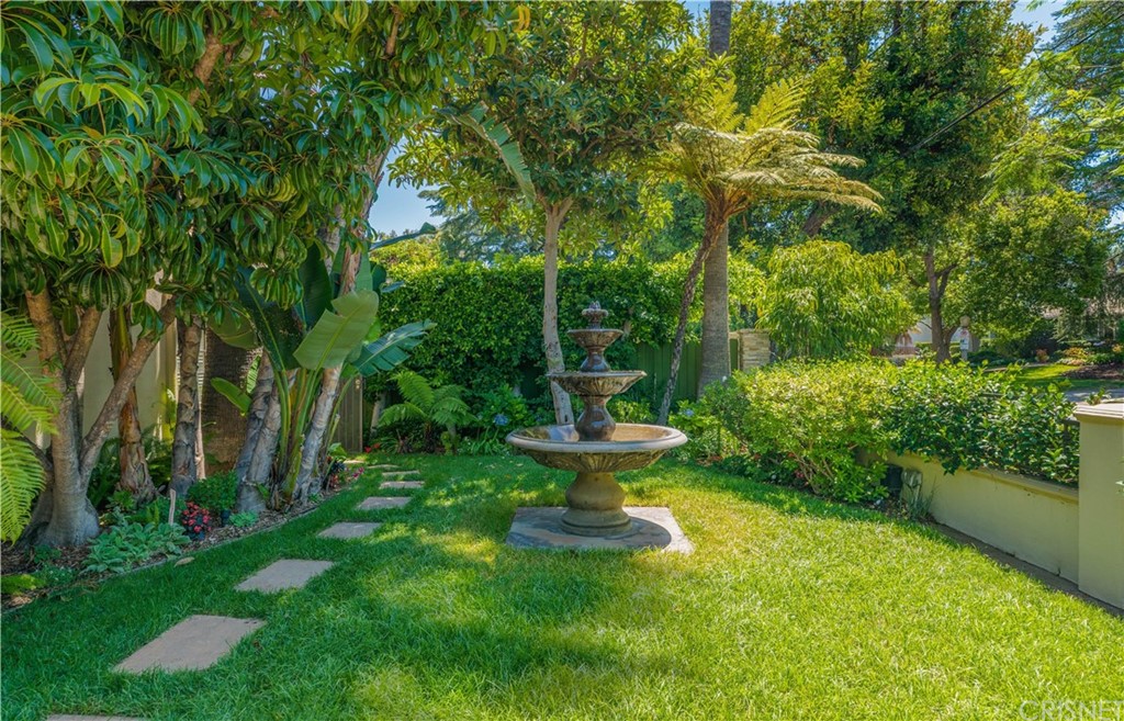 15237 Sutton Street Sherman Oaks, CA 91403 - Photo 22 of 31 a view of a fountain in the garden with large trees