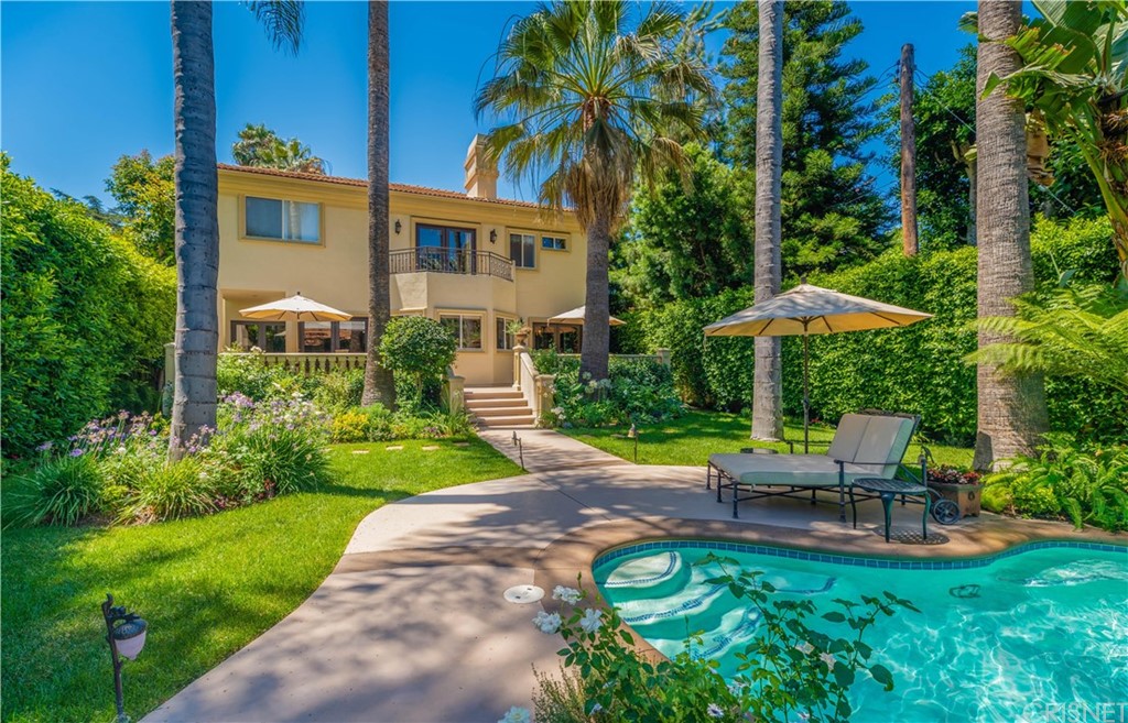 15237 Sutton Street Sherman Oaks, CA 91403 - Photo 24 of 31 a view of swimming pool with a table and chairs under an umbrella
