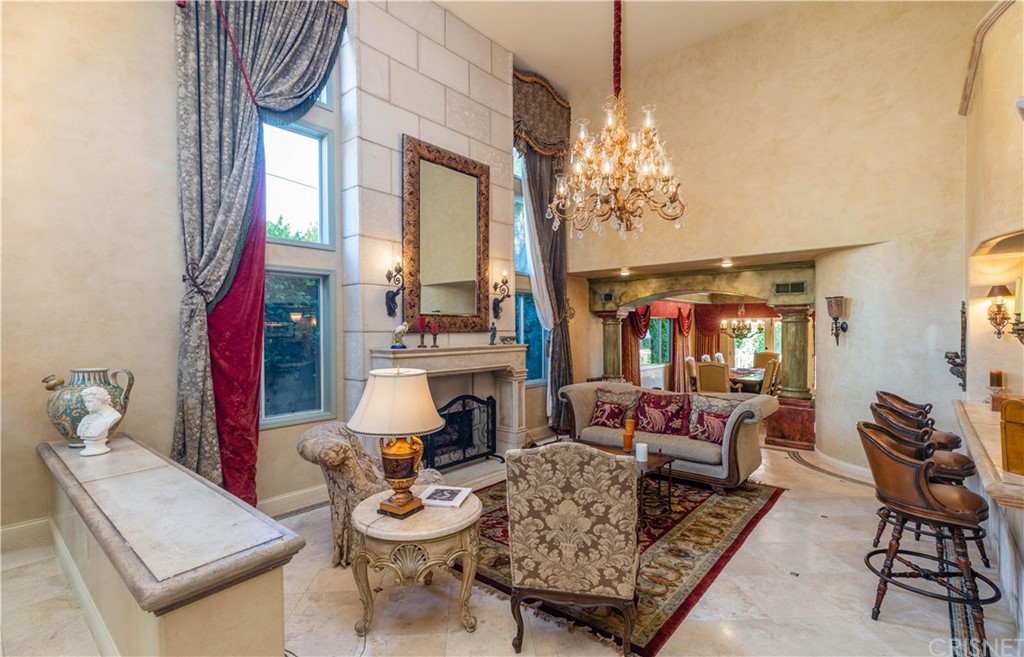 15237 Sutton Street Sherman Oaks, CA 91403 - Photo 6 of 31 a living room with furniture a chandelier and a fireplace