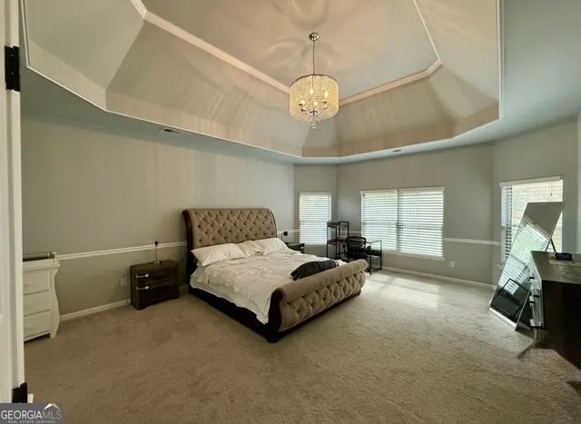 a spacious bedroom with a bed and window