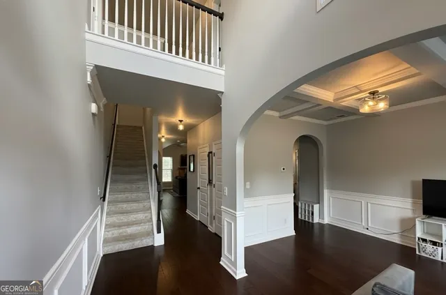 a view of entryway and hall with wooden floor