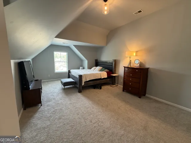 a view of a hallway with wooden floor and stairs