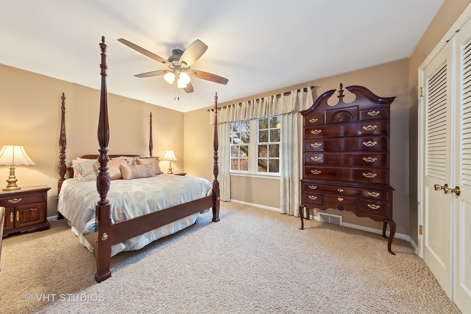 1140 Woodview Road Burr Ridge, IL 60527 - Photo 22 of 35 a bedroom with a bed a dresser and a chandelier