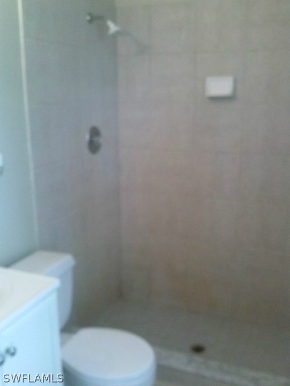 9099 Henry Road Fort Myers, FL 33967 - Photo 7 of 10 a white toilet sitting next to a shower