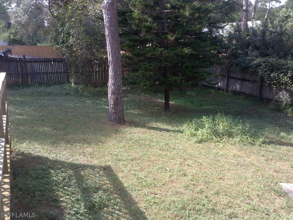 9099 Henry Road Fort Myers, FL 33967 - Photo 9 of 10 a backyard of a house with lots of green space
