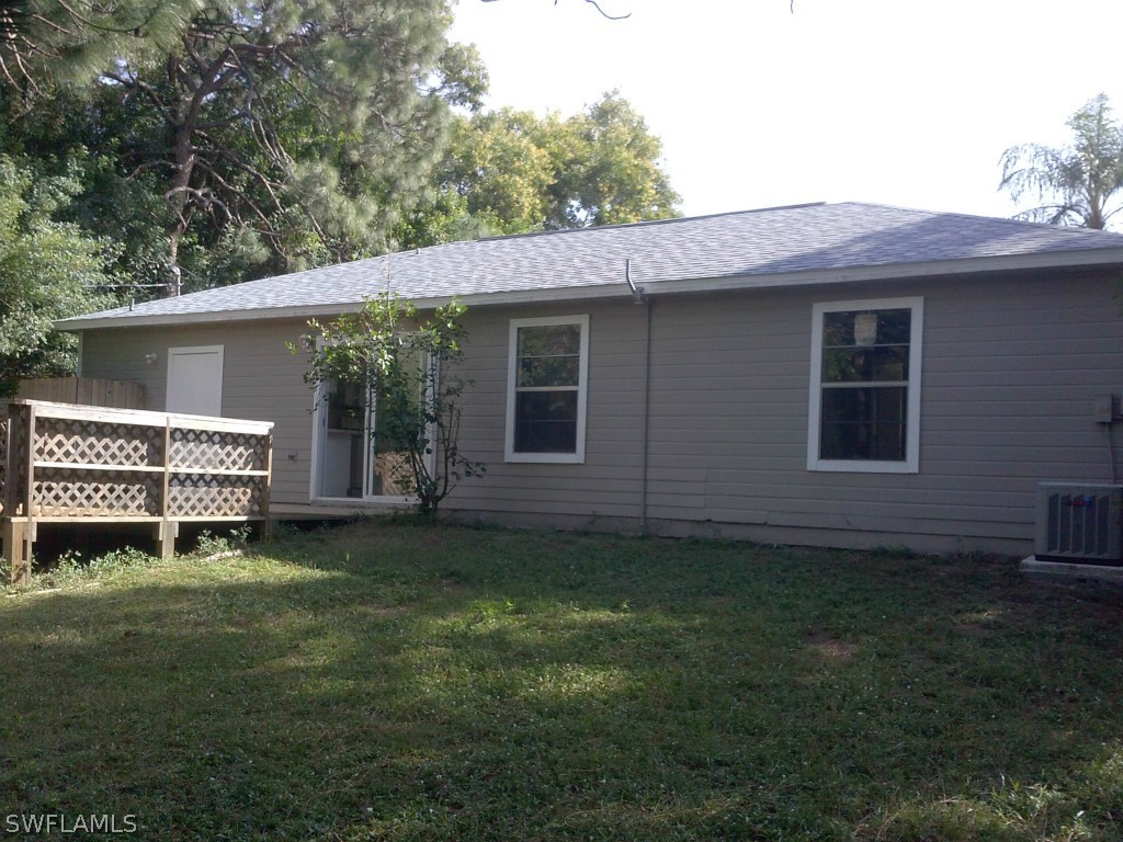 9099 Henry Road Fort Myers, FL 33967 - Photo 10 of 10 a backyard of a house with table and chairs