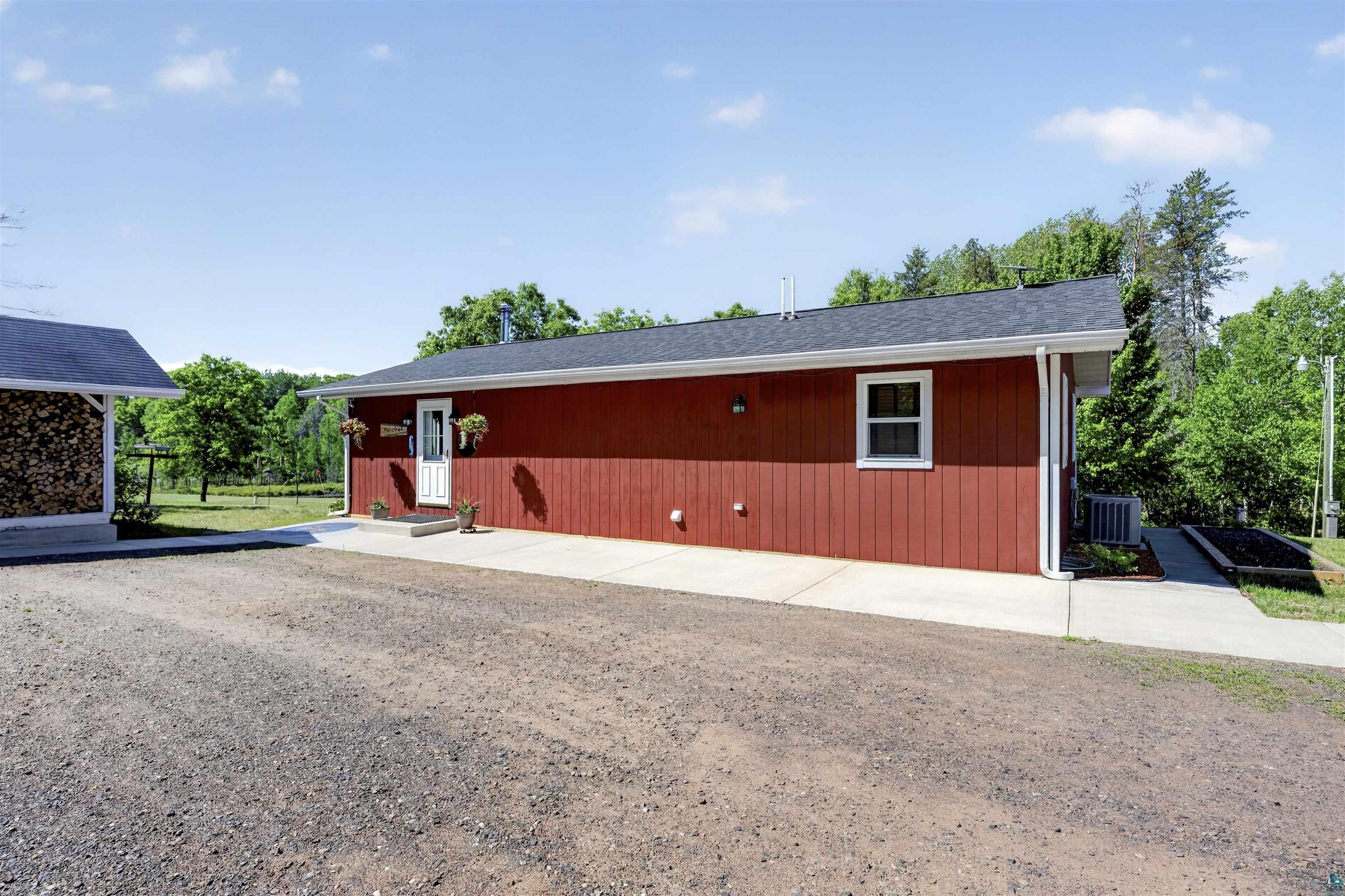 11702 East Mail Road Gordon, WI 54838 - Photo 33 of 60 Red vertical siding exterior with white trim