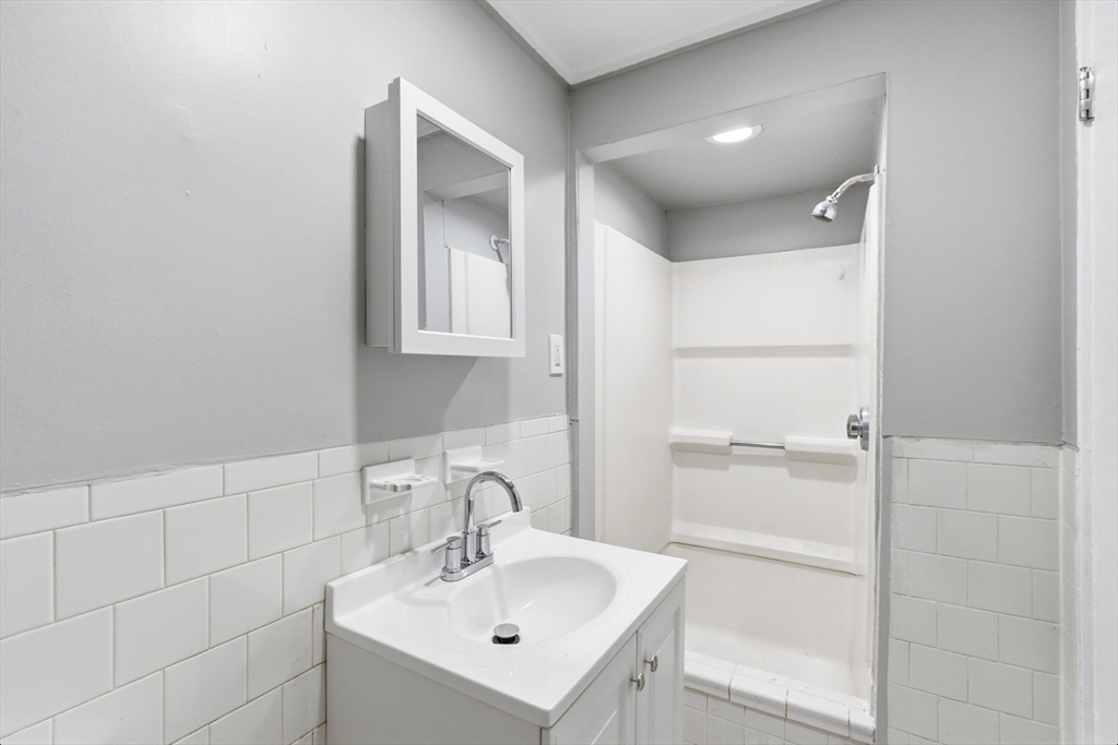 204 Washington Street, Unit 1 Somerville, MA 02143 - Photo 13 of 19 a bathroom with a sink and a mirror