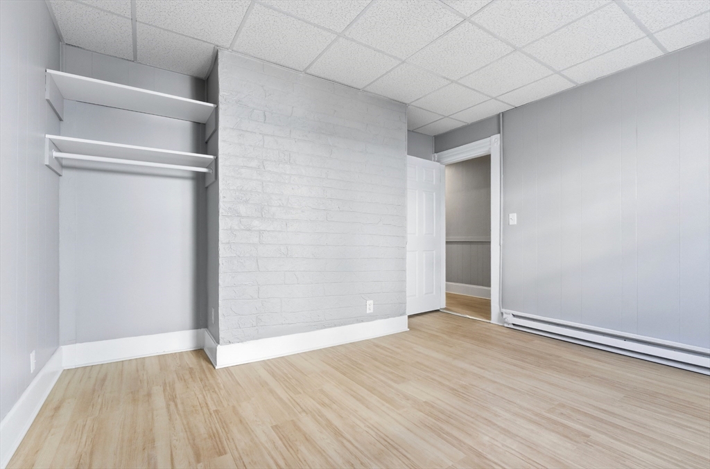 204 Washington Street, Unit 1 Somerville, MA 02143 - Photo 7 of 19 a view of an empty room with wooden floor