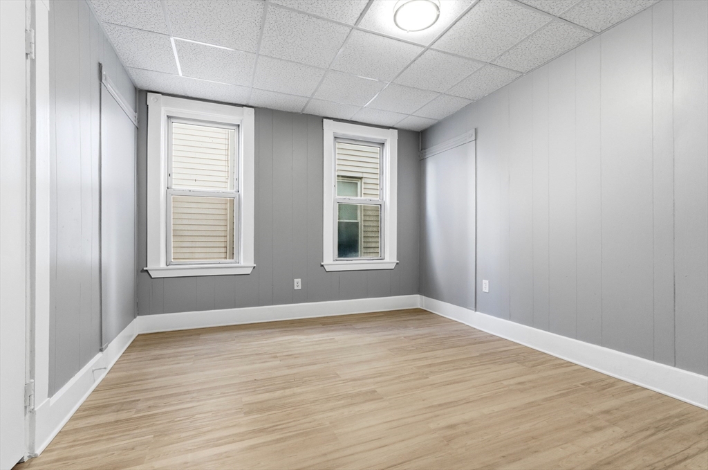 204 Washington Street, Unit 1 Somerville, MA 02143 - Photo 10 of 19 a view of an empty room with wooden floor and a window