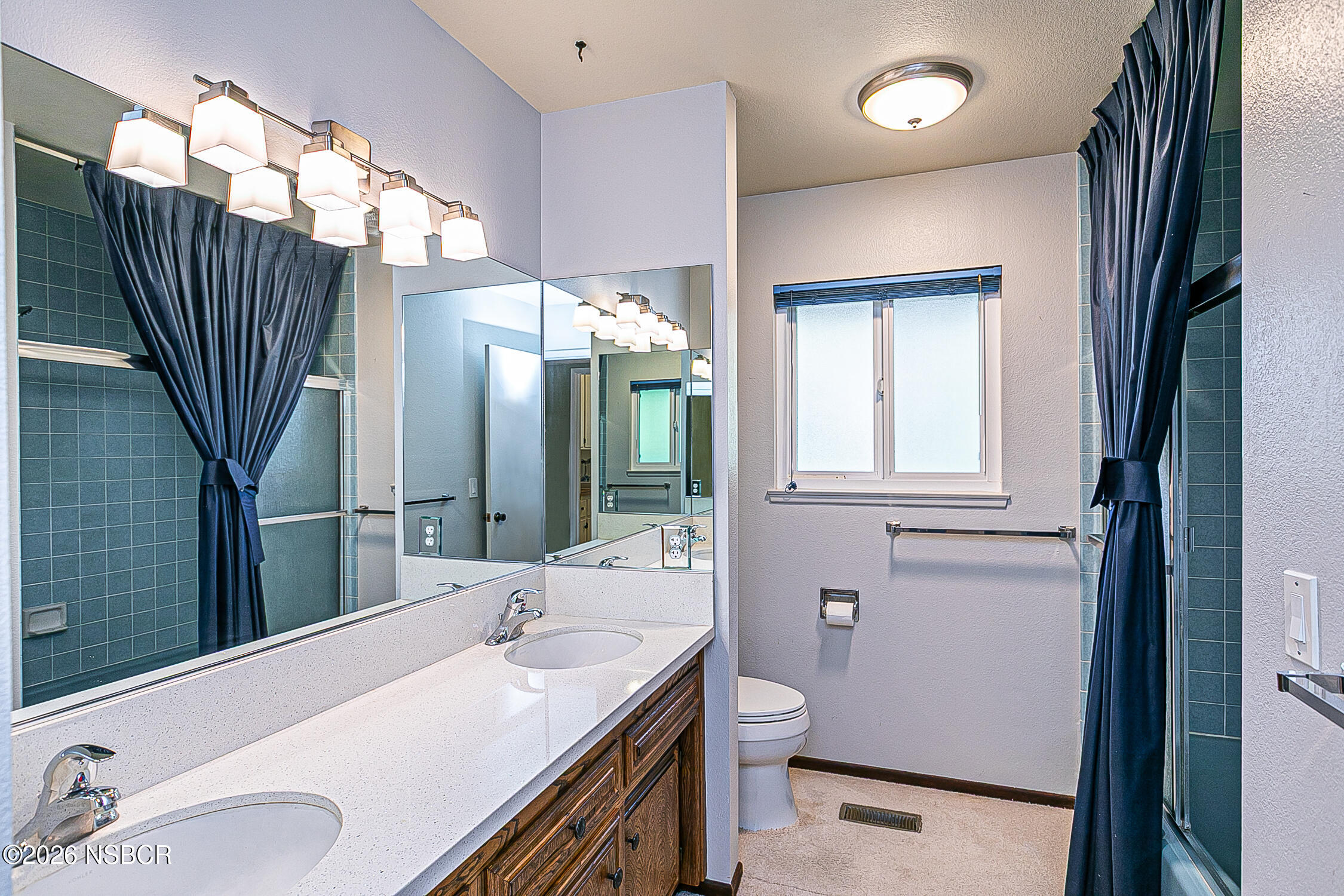 1260 Onstott Road Lompoc, CA 93436 - Photo 36 of 52 a bathroom with a sink a toilet and mirror