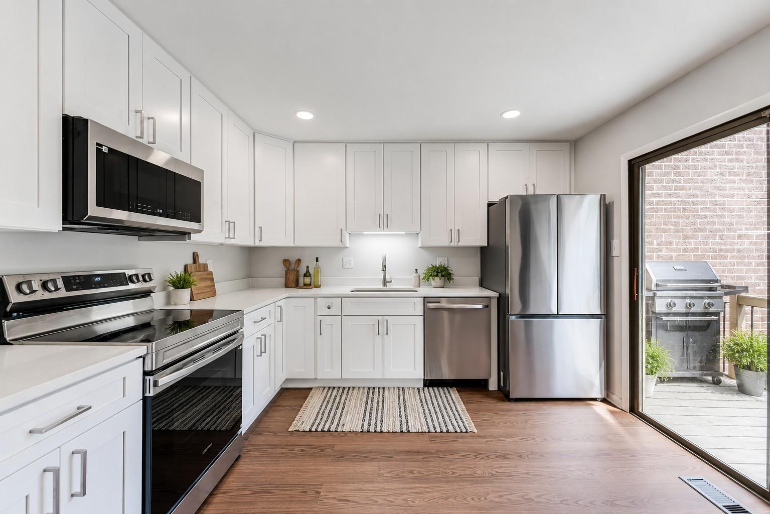 12023 Insha Court Reston, VA 20191 - Photo 19 of 52 a kitchen with a refrigerator stove and microwave