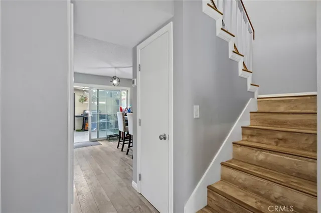 a view of entryway and hall with wooden floor
