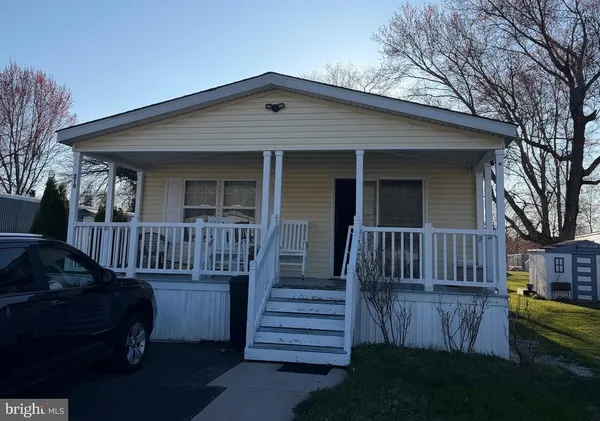 a view of a house with wooden deck and a yard