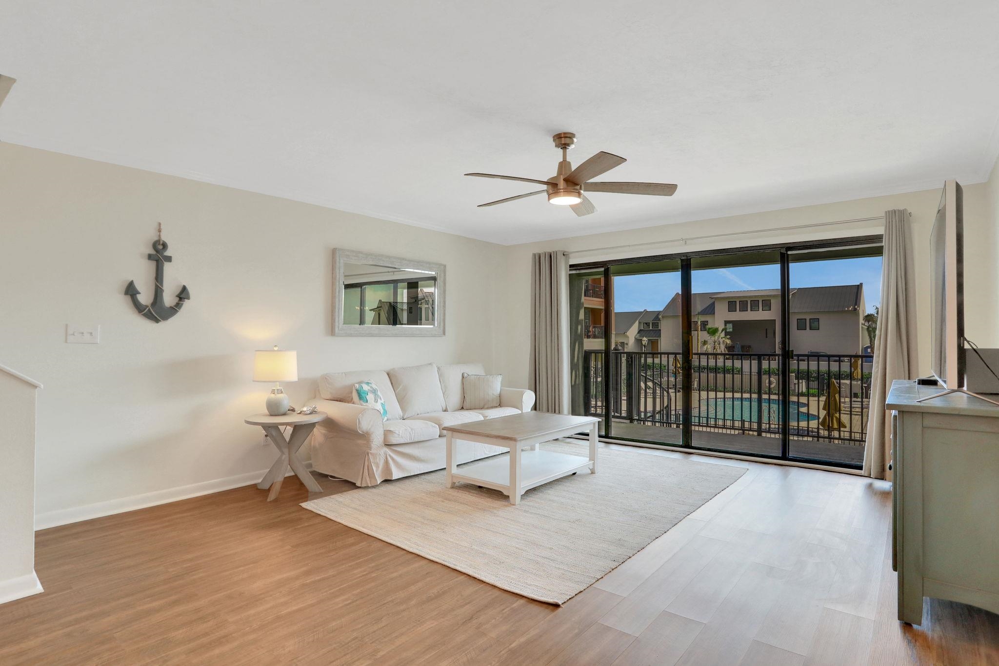 120 Sunset Harbor Way, Unit 202 St. Augustine, FL 32080 - Photo 14 of 50 a living room with furniture large window and wooden floor