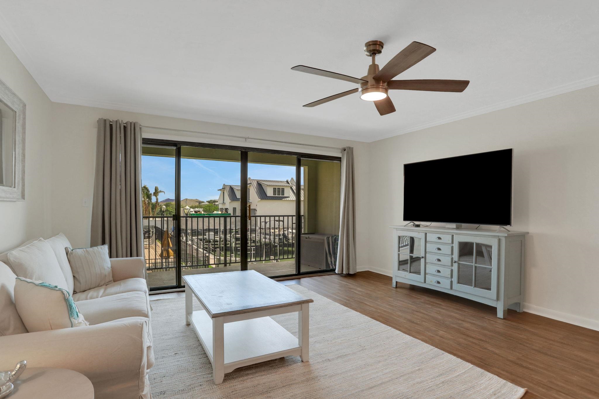 120 Sunset Harbor Way, Unit 202 St. Augustine, FL 32080 - Photo 15 of 50 a living room with furniture and a flat screen tv